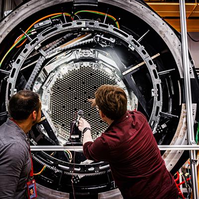 Two scientists in front of MOONS rotating front end.