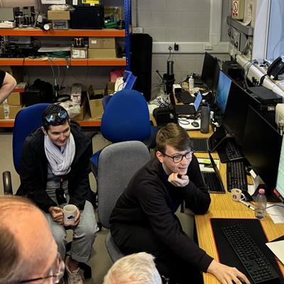 The MOONS software team gathered around a computer in the lab at UK ATC.